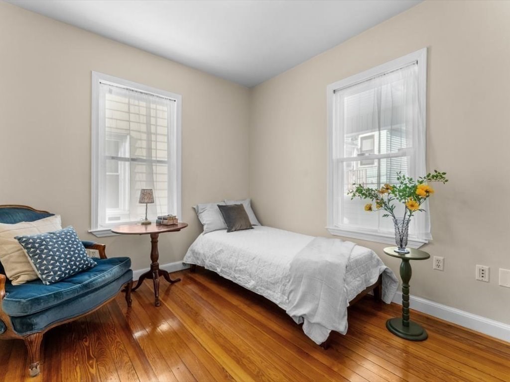 11 Doris Street, Unit 1 Boston, MA 02125 - Photo 13 of 17 a bedroom with a bed table chair and a window