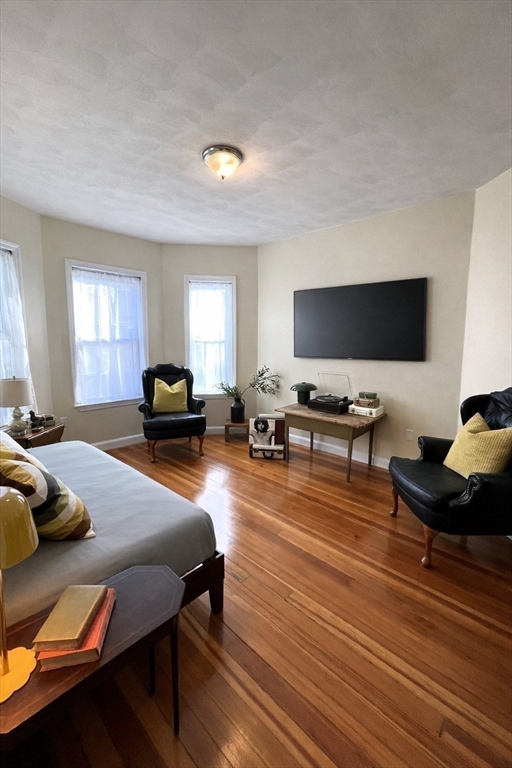 11 Doris Street, Unit 1 Boston, MA 02125 - Photo 6 of 17 a living room with furniture and a flat screen tv
