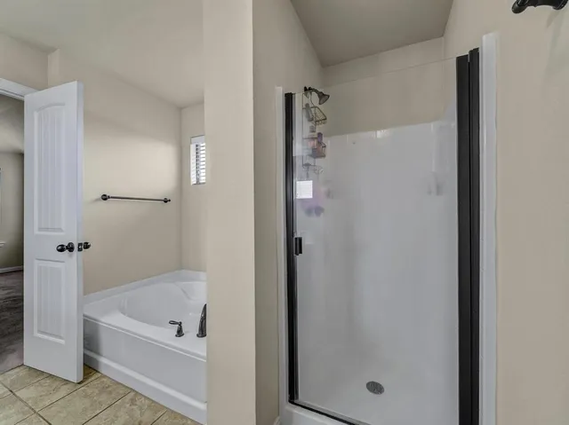 a bathroom with a tub shower and vanity