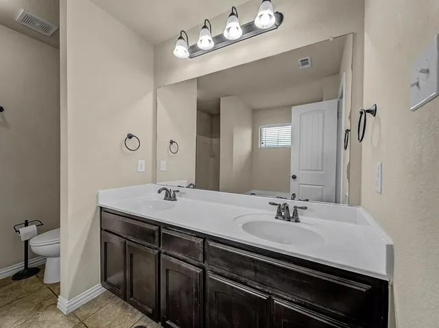 a bathroom with a sink double vanity and a mirror