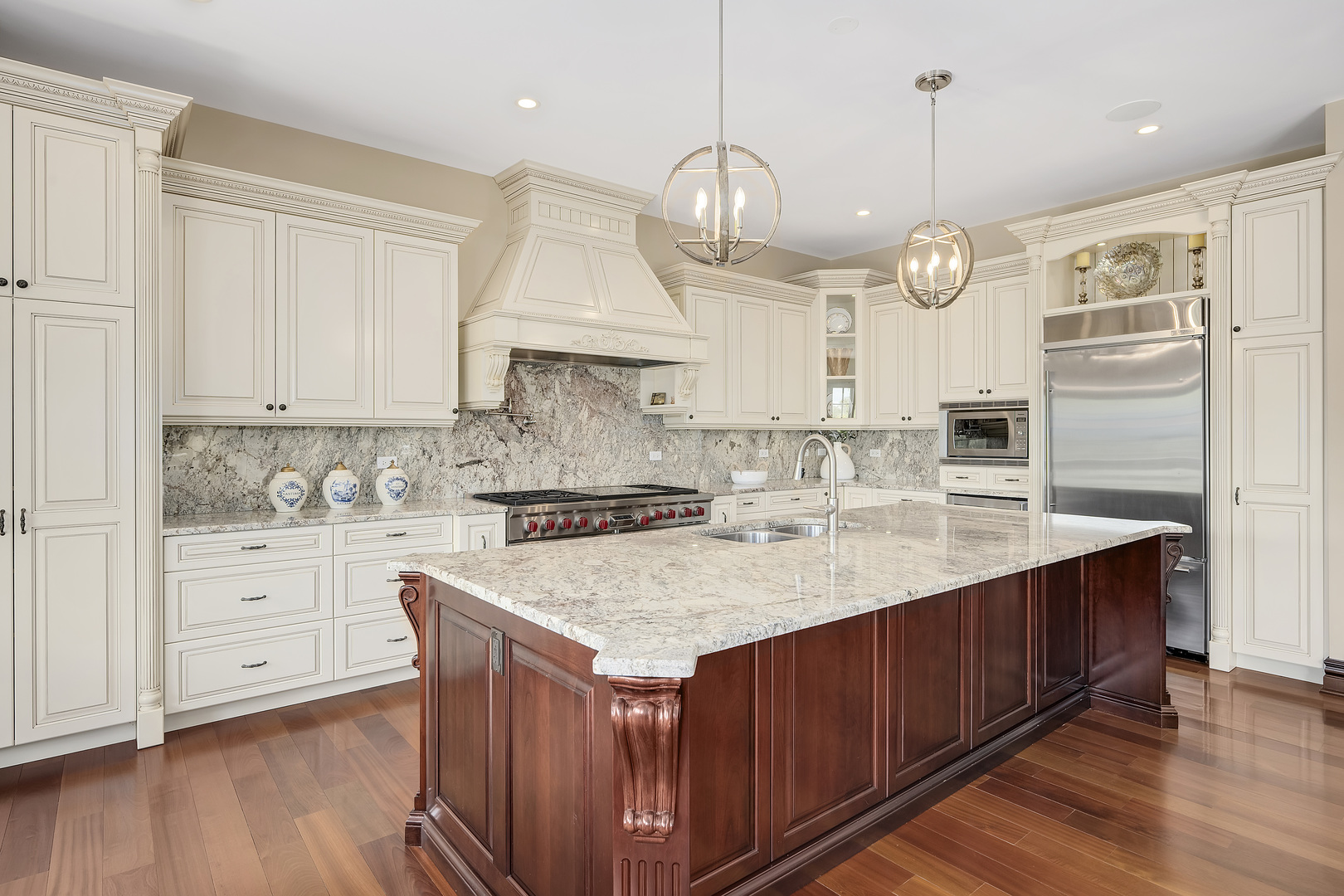 8511 Kearney Road Downers Grove, IL 60516 - Photo 26 of 71 a kitchen with kitchen island granite countertop wooden floors and white cabinets