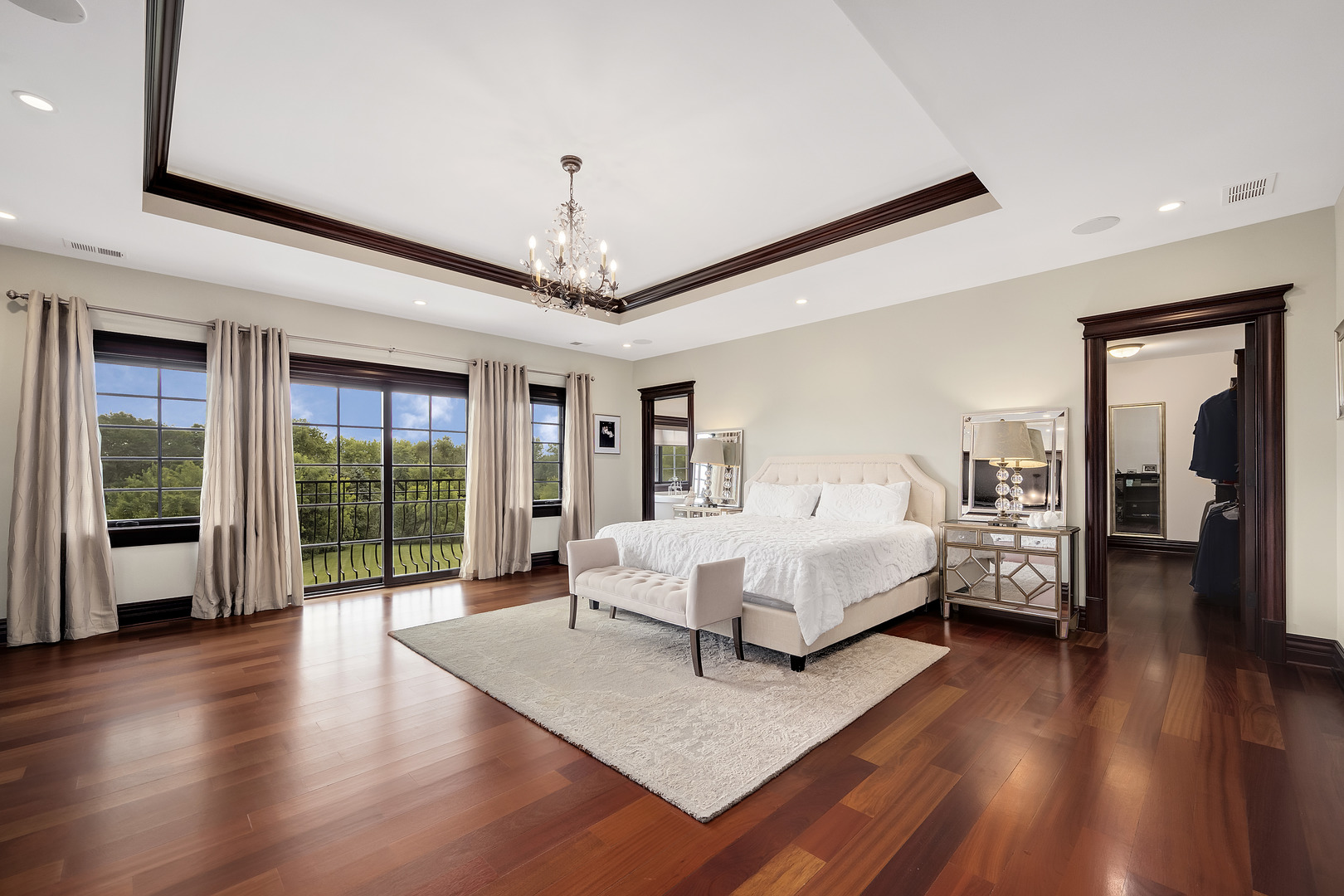 8511 Kearney Road Downers Grove, IL 60516 - Photo 43 of 71 a spacious bedroom with a large bed and a chandelier