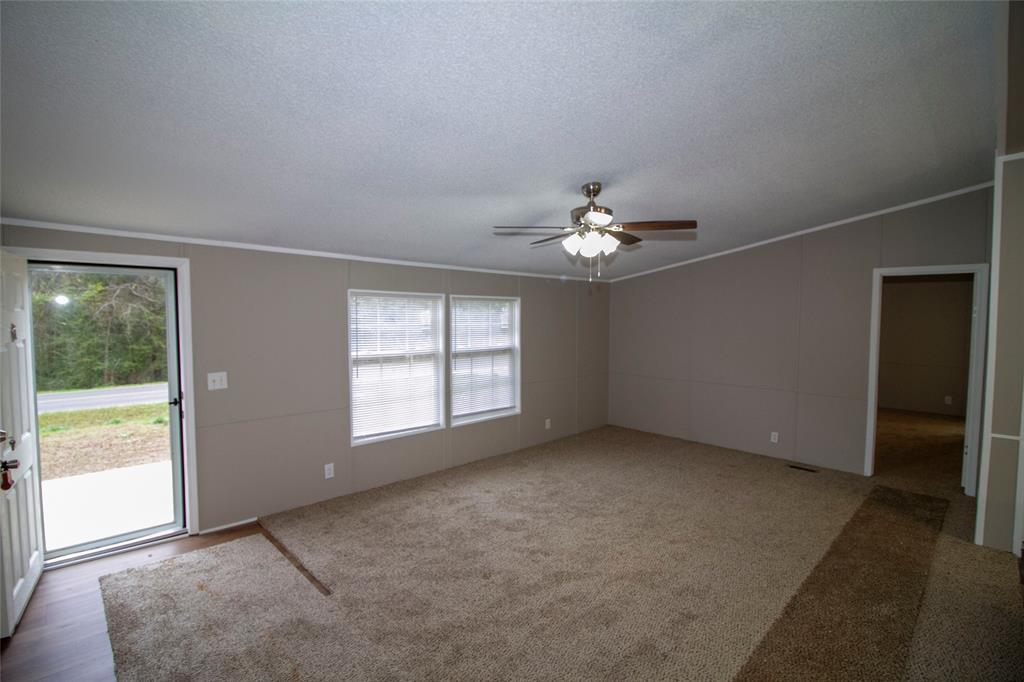 909 Old Arcadia Road Minden, LA 71055 - Photo 4 of 21 an empty room with chandelier fan and windows