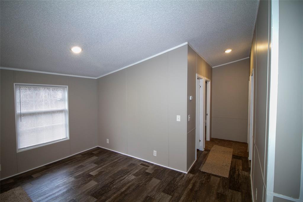 909 Old Arcadia Road Minden, LA 71055 - Photo 7 of 21 a view of an empty room with wooden floor and a window