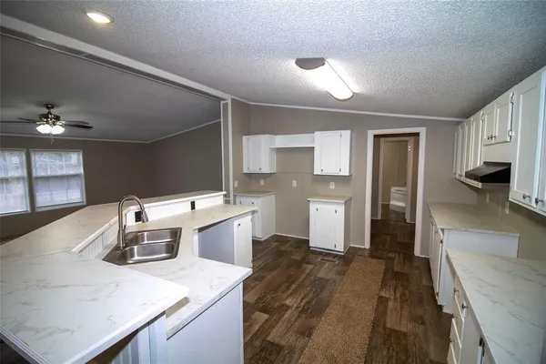 a kitchen that has a lot of cabinets and refrigerator