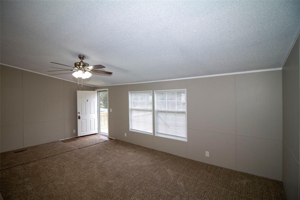 909 Old Arcadia Road Minden, LA 71055 - Photo 10 of 21 an empty room with chandelier fan and windows