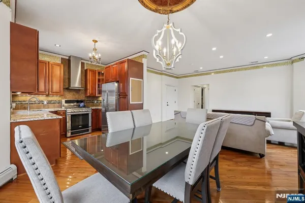 a kitchen with stainless steel appliances granite countertop a stove a sink and a refrigerator