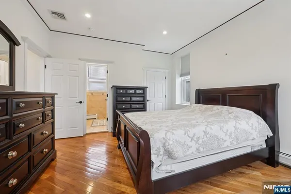 a bedroom with a bed and a dresser