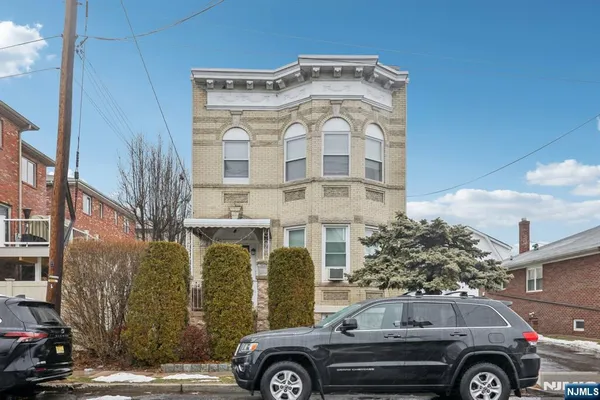 a front view of a house with parking space