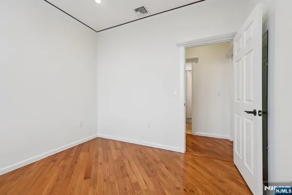 a view of a room with wooden floor