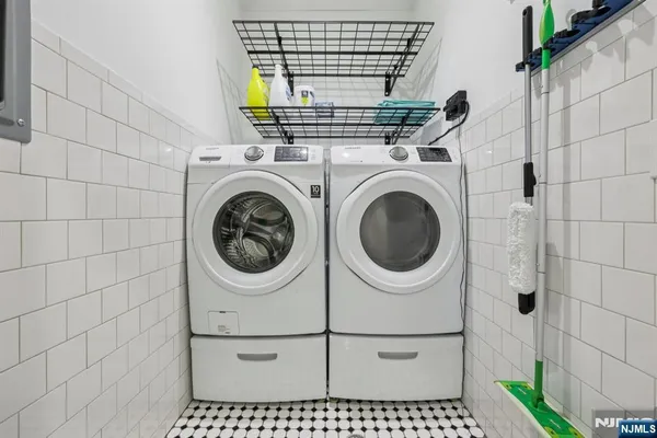 a roof deck with couch and chairs