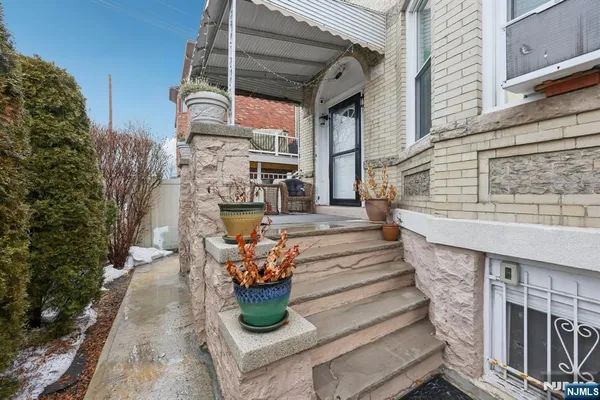 a view of a hallway with wooden floor and entryway
