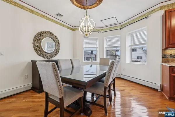 a view of a dining room with furniture wooden floor and chandelier