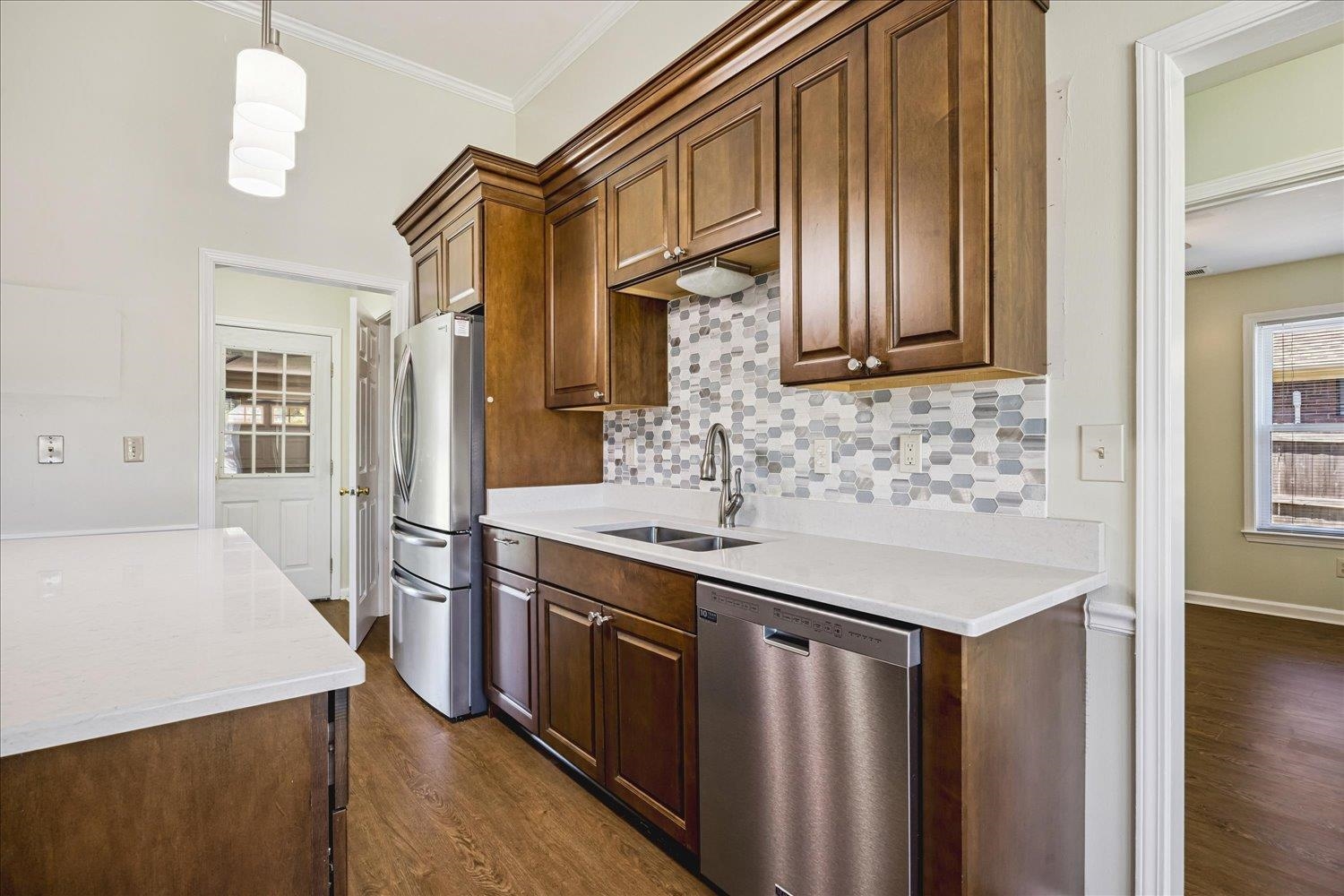 4654 Shadow Wick Lane Bartlett, TN 38002 - Photo 12 of 26 Kitchen featuring wood-finish cabinetry, white countertops, and a mosaic tile backsplash
