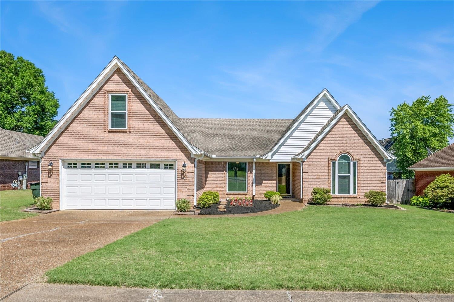 4654 Shadow Wick Lane Bartlett, TN 38002 - Photo 2 of 26 Brick facade with white siding accents and a two-car garage