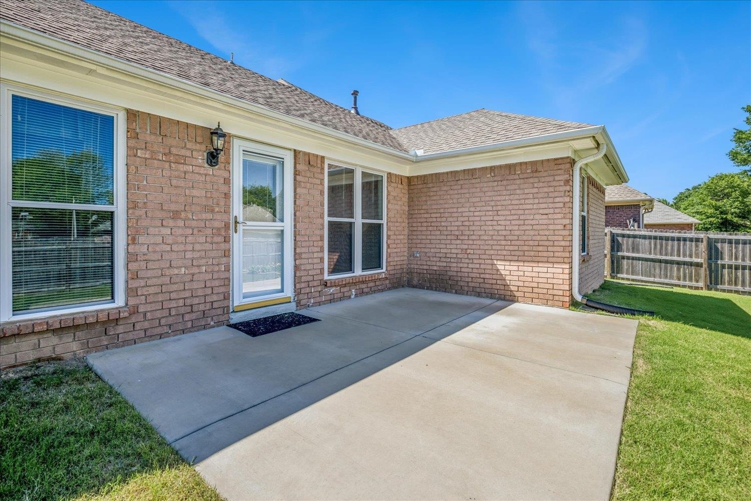 4654 Shadow Wick Lane Bartlett, TN 38002 - Photo 24 of 26 Expansive concrete patio with brick exterior and white trim