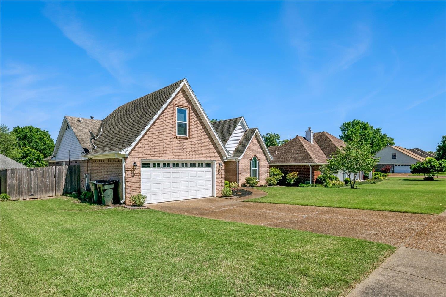4654 Shadow Wick Lane Bartlett, TN 38002 - Photo 4 of 26 Brick exterior with a gabled roofline and a two-car garage