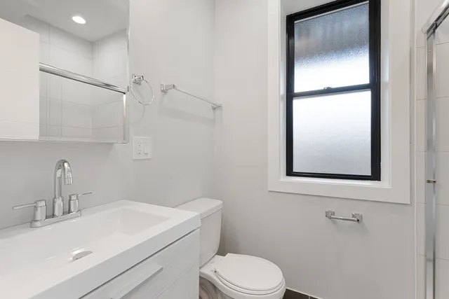 a bathroom with a sink toilet and vanity
