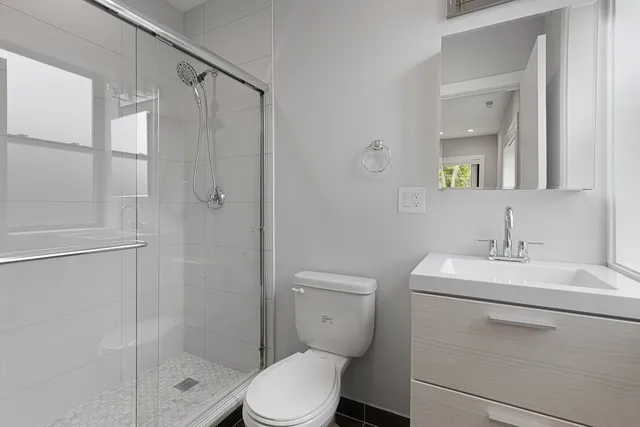 a bathroom with a toilet a sink and shower