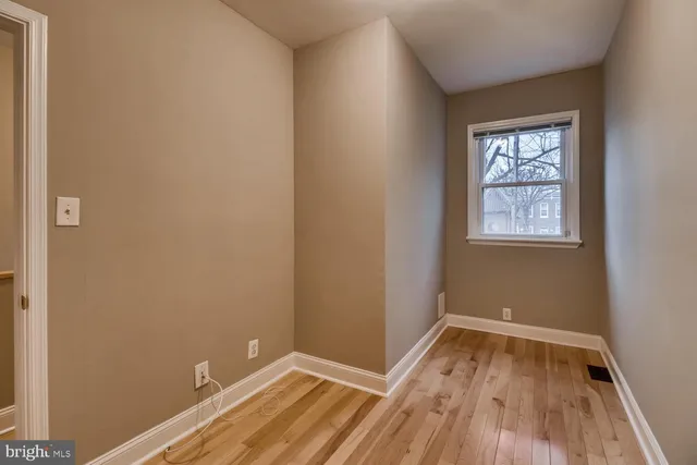 a view of a room with wooden floor and window