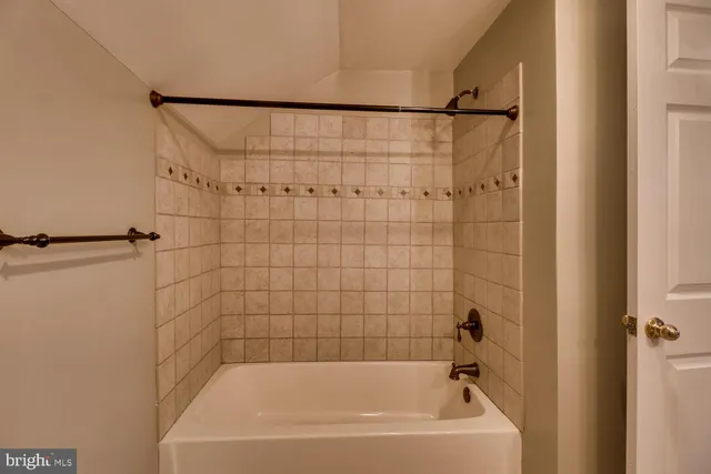 a bathroom with a granite countertop sink vanity mirror and a