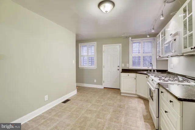 a kitchen with a stove a sink and a refrigerator