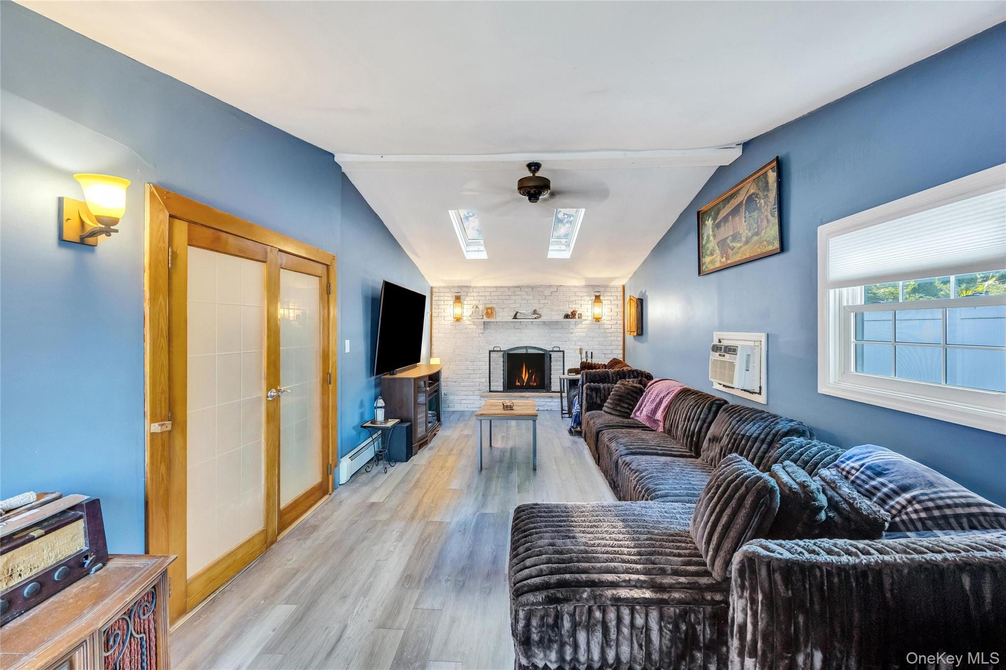 7 Amherst Road Ronkonkoma, NY 11779 - Photo 22 of 36 a living room with furniture fireplace and flat screen tv