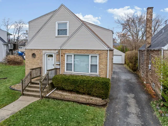 a front view of a house with a yard and outdoor seating