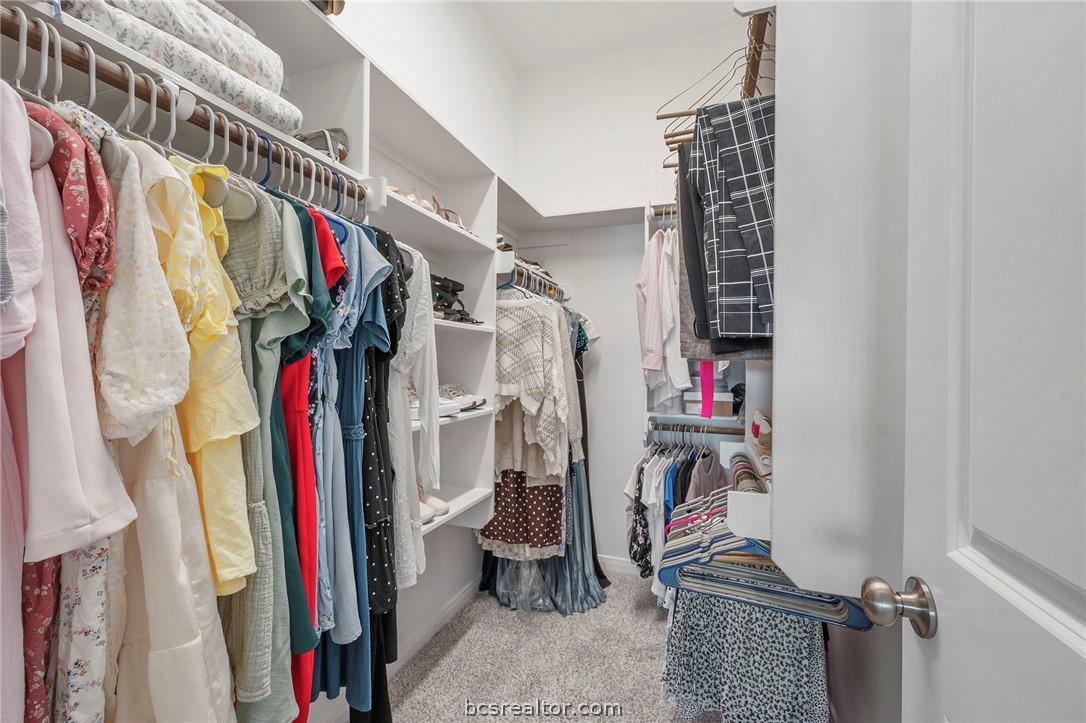 2038 Viva Road Bryan, TX 77807 - Photo 13 of 21 Expansive walk-in primary closet with built-in shelving and abundant hanging space.