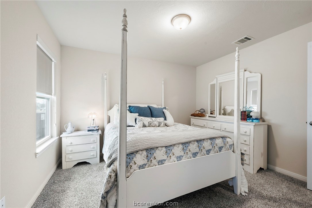 2038 Viva Road Bryan, TX 77807 - Photo 15 of 21 Secondary bedroom with bright natural light and comfortable layout for family or guests.