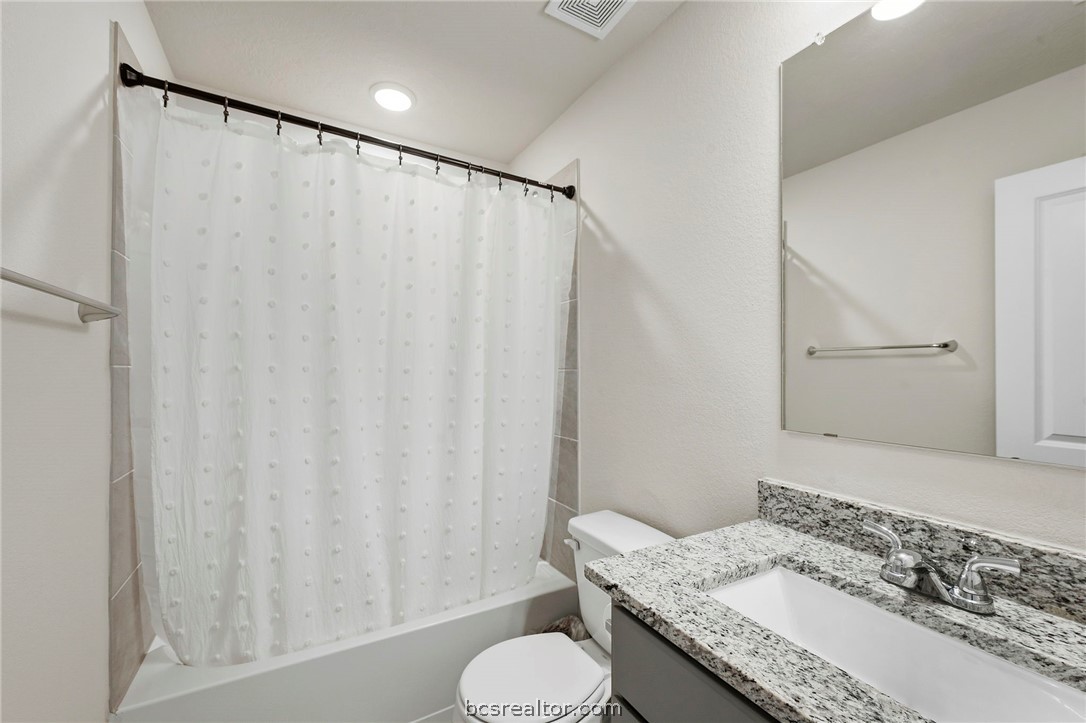 2038 Viva Road Bryan, TX 77807 - Photo 16 of 21 Full guest bath with granite vanity and clean modern finishes.