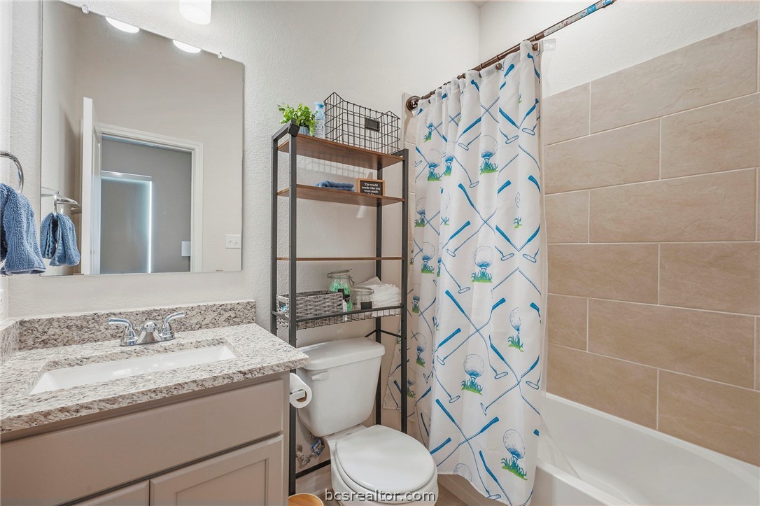 2038 Viva Road Bryan, TX 77807 - Photo 18 of 21 Full ensuite guest bath with granite vanity and clean modern finishes.