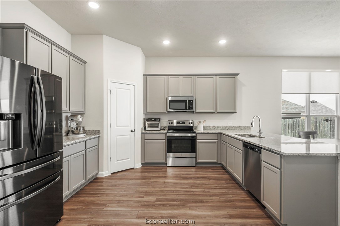 2038 Viva Road Bryan, TX 77807 - Photo 4 of 21 Functional island kitchen with ample cabinetry and seamless flow into the main living areas.