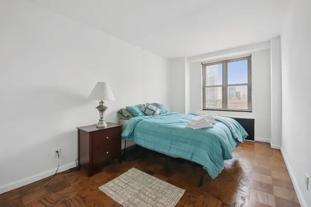 a bedroom with a bed and window