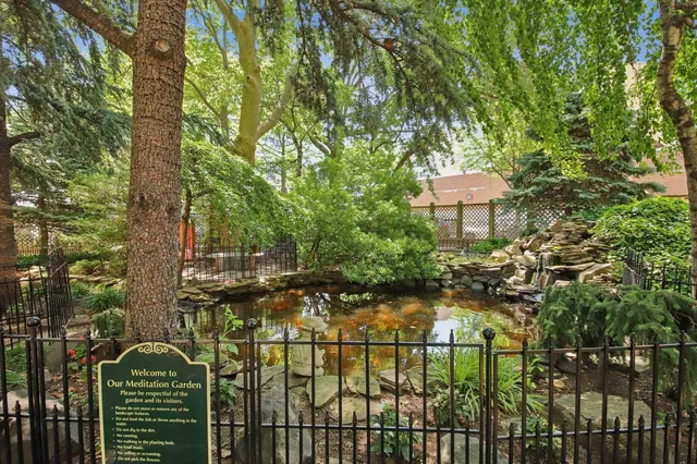 a view of a swimming pool with a bench and lawn chairs