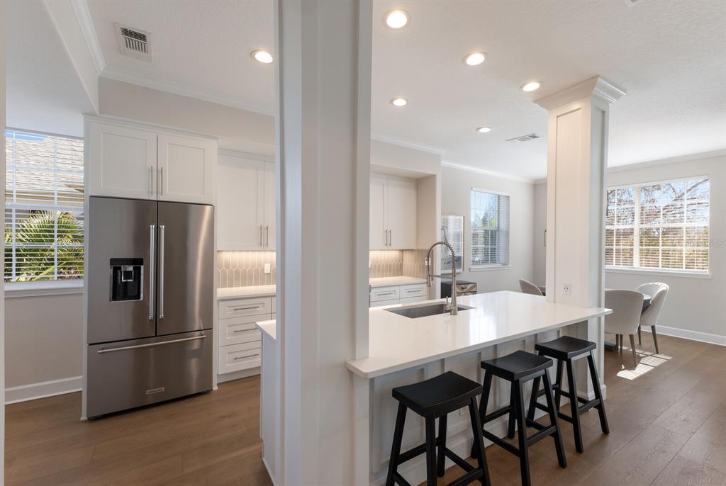 8035 St Simons Street, Unit 8035 University Park, FL 34201 - Photo 11 of 39 a kitchen with stainless steel appliances a dining table chairs and refrigerator