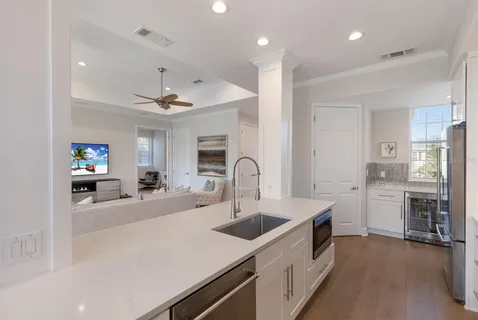 a kitchen with kitchen island a sink appliances and cabinets