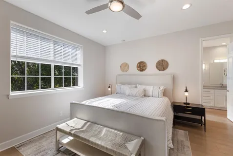 a bedroom with a bed and a window