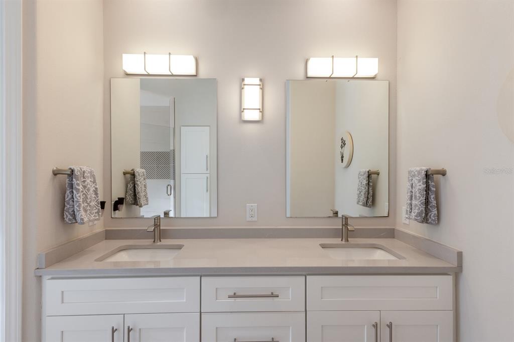 8035 St Simons Street, Unit 8035 University Park, FL 34201 - Photo 23 of 39 a bathroom with double vanity sinks and a mirror