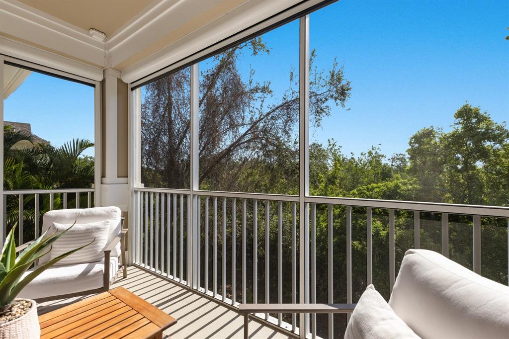 8035 St Simons Street, Unit 8035 University Park, FL 34201 - Photo 30 of 39 a balcony with wooden floor table and chairs