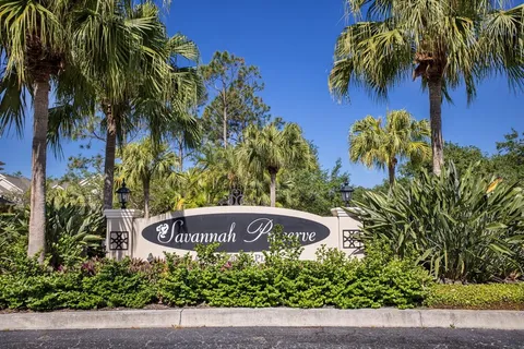 a street sign that is sitting in front of a house