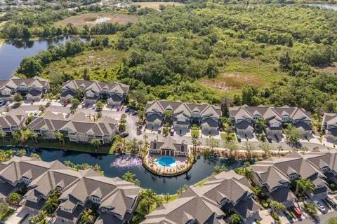 an aerial view of a house with garden space and lake view