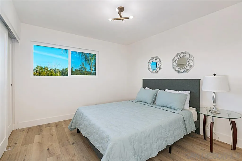 2760 Lone Jack Road Encinitas, CA 92024 - Photo 16 of 25 a bedroom with a bed and a painting on the wall