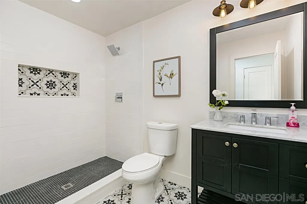 2760 Lone Jack Road Encinitas, CA 92024 - Photo 17 of 25 a bathroom with a toilet sink and mirror