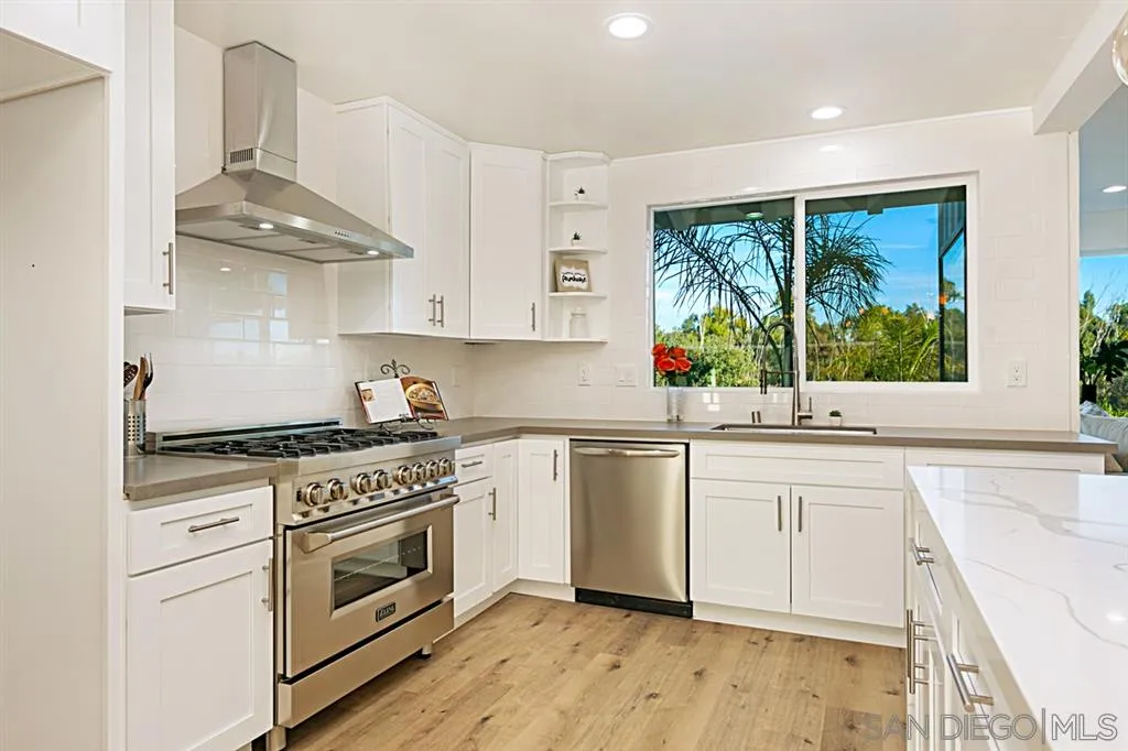2760 Lone Jack Road Encinitas, CA 92024 - Photo 5 of 25 a kitchen with stainless steel appliances a stove a sink and a refrigerator