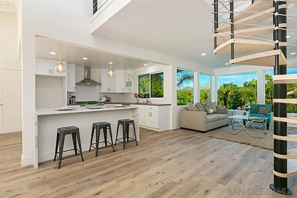 2760 Lone Jack Road Encinitas, CA 92024 - Photo 6 of 25 a living room with kitchen island furniture a kitchen view and a large window