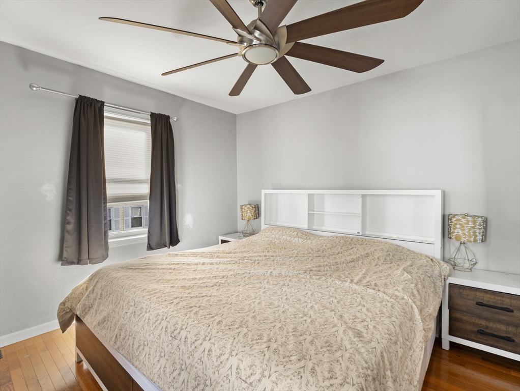 95 South Highland Street Lowell, MA 01852 - Photo 12 of 41 a bedroom with a large bed and a large window
