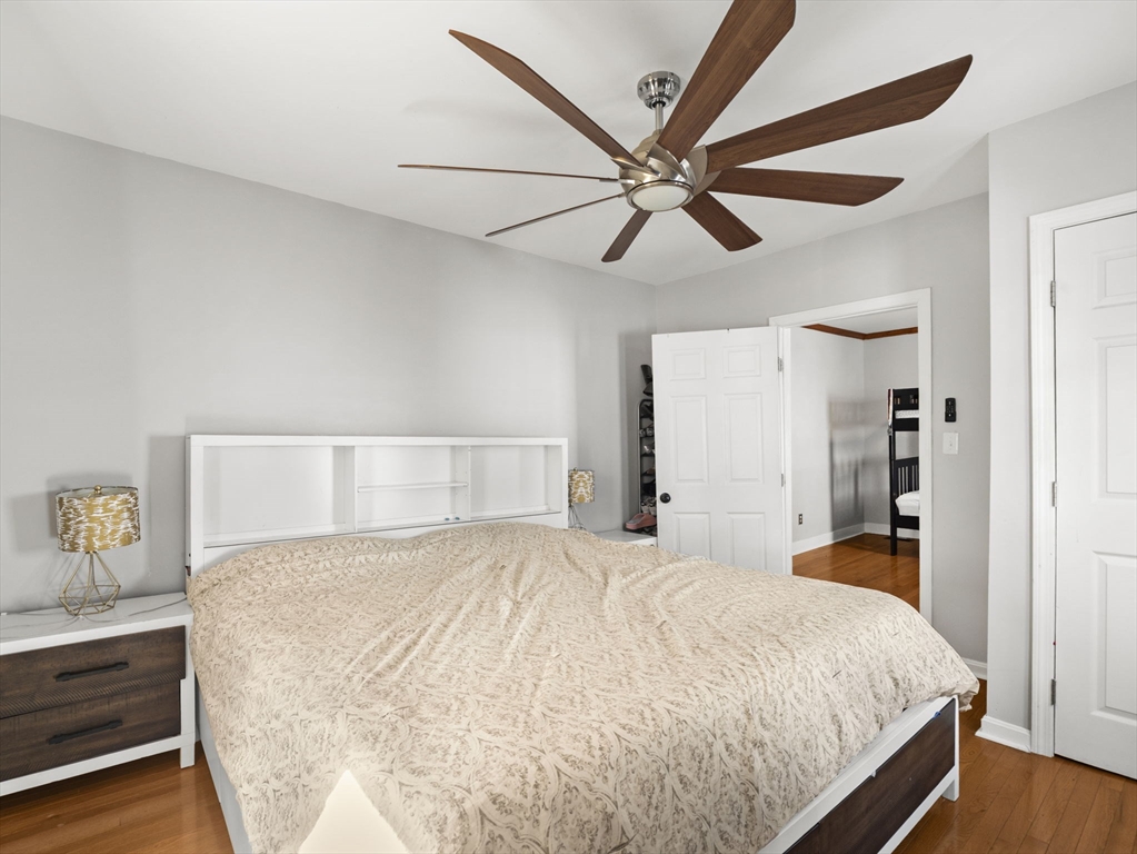 95 South Highland Street Lowell, MA 01852 - Photo 13 of 41 a bedroom with a large bed and a chandelier