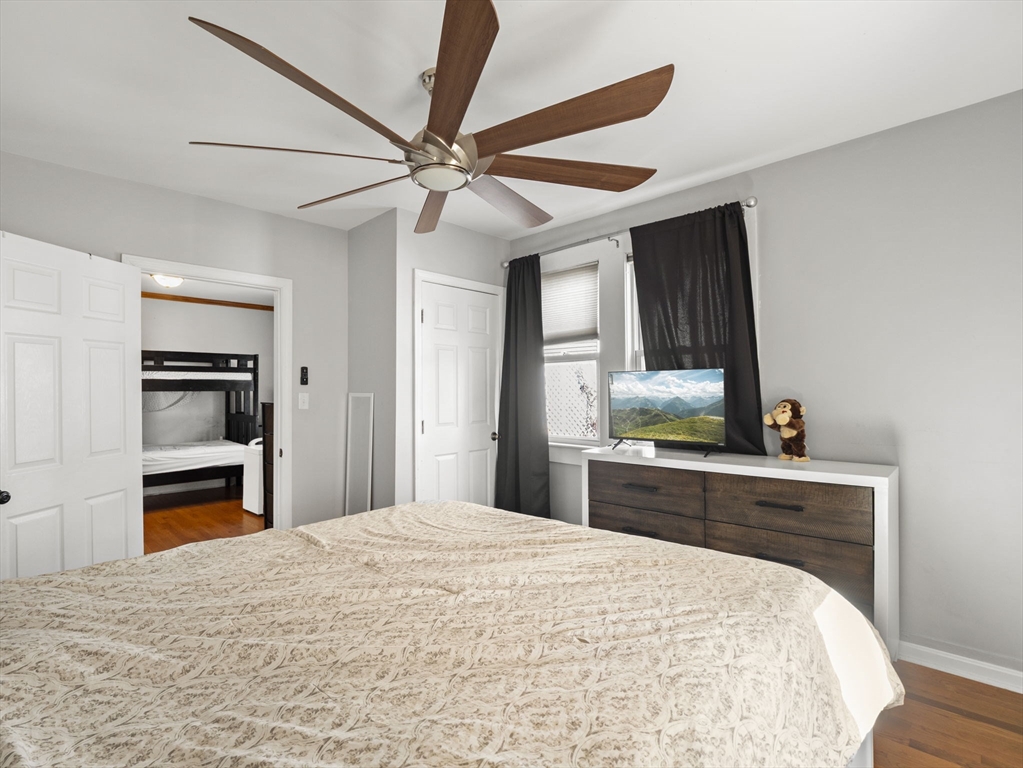 95 South Highland Street Lowell, MA 01852 - Photo 14 of 41 a bedroom with a bed and a chandelier