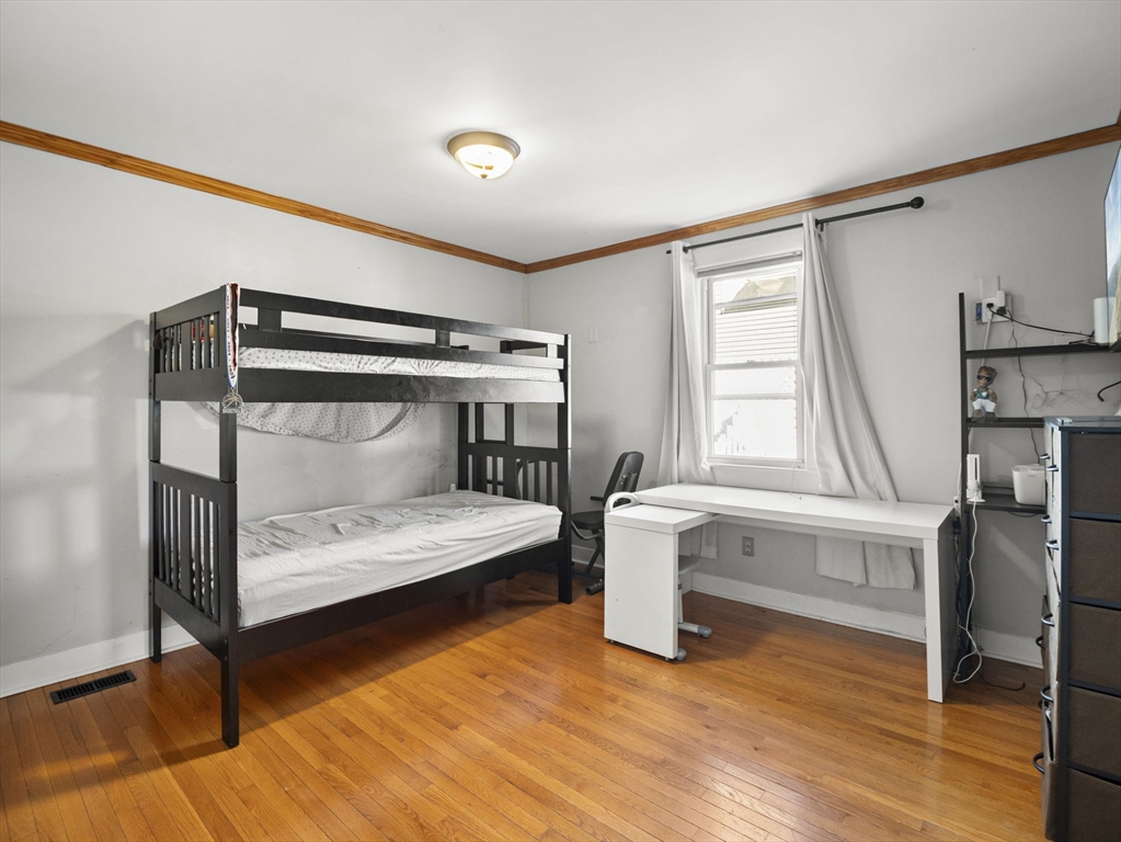 95 South Highland Street Lowell, MA 01852 - Photo 15 of 41 a bedroom with a bed and windows